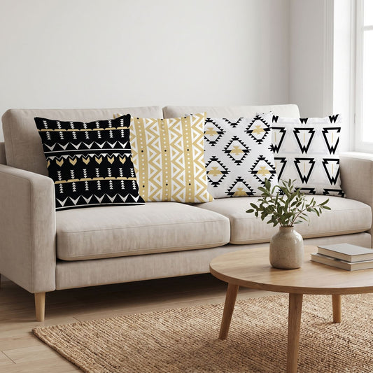 Aztec Gold — set of four printed cushions on a sofa — Karen Fabrics