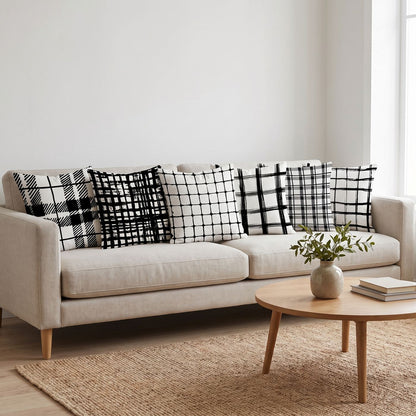 Ink Grid — set of six printed cushions on a sofa — Karen Fabrics